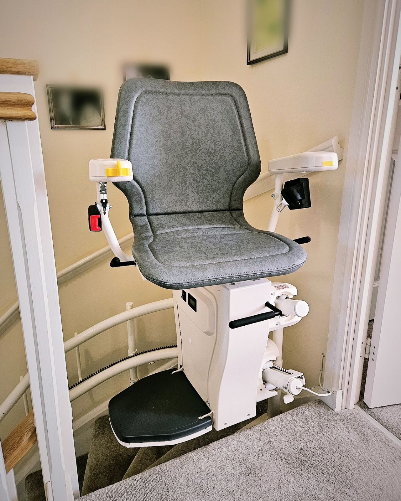 Curved stair lift following a winding staircase in a Cleveland Ohio home, designed for safe and continuous movement between levels
