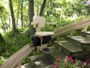 Outdoor stair lift installed on exterior steps during winter